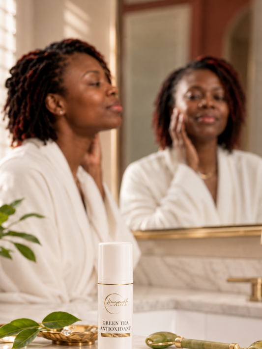 Woman applying skincare product in front of a mirror with a bottle of skincare serum on the counter.