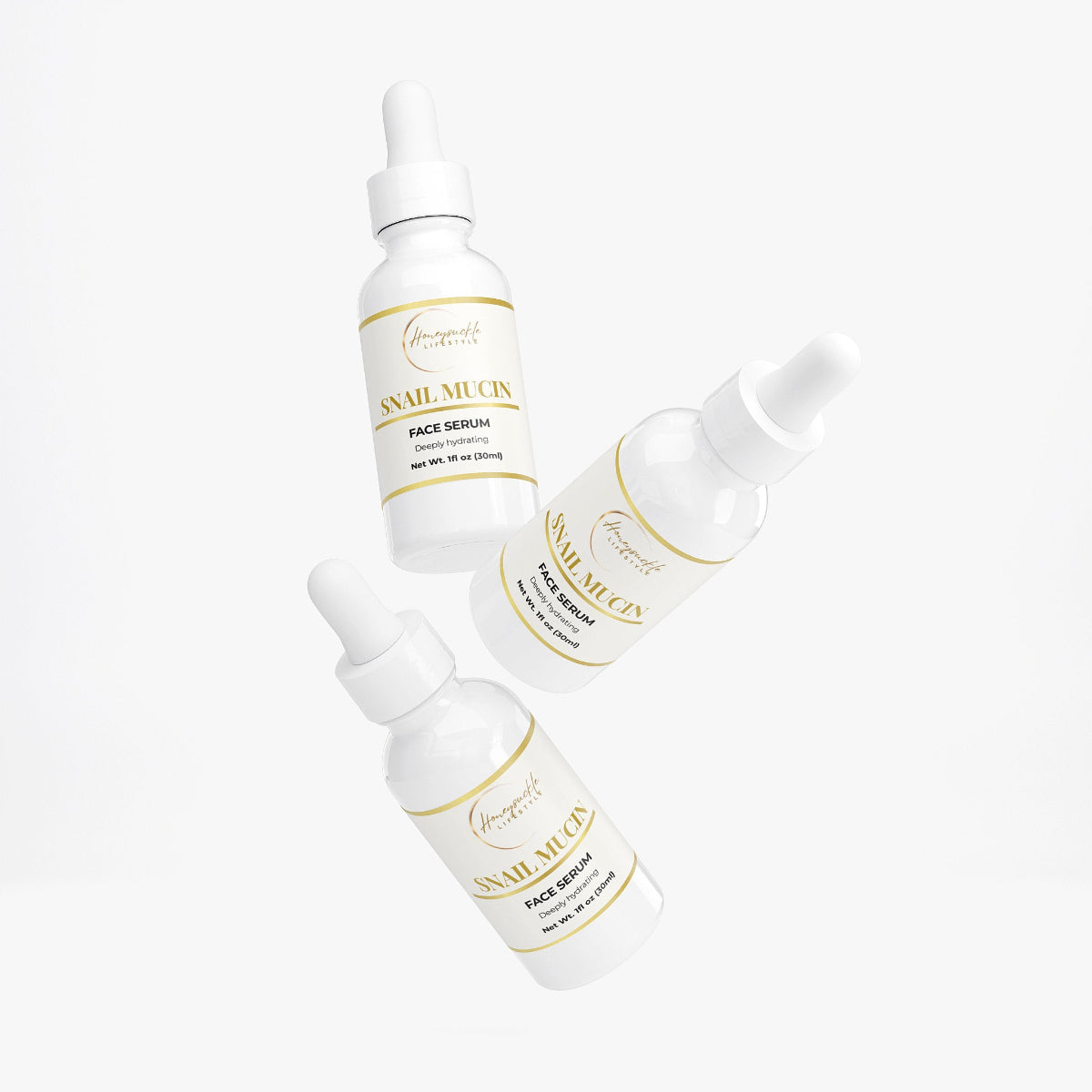 Three bottles of Snail Mucin Face Serum on a white background