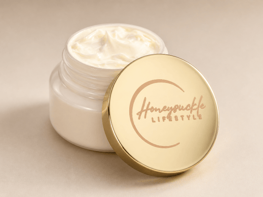 Open jar of cream with a gold lid featuring 'HoneySuckle Lifestyle' on a beige background