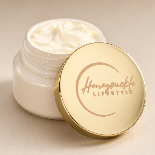 Open jar of cream with a gold lid featuring 'HoneySuckle Lifestyle' on a beige background