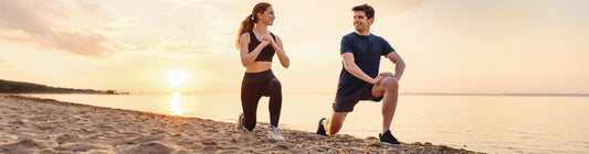 Man & Woman stretching after running on the beach