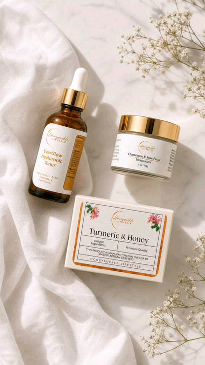 Cosmetic products including everglow dropper bottle, chamomile and rose facial moisturizer jar, and turmeric soap on a soft white fabric background with flowers.