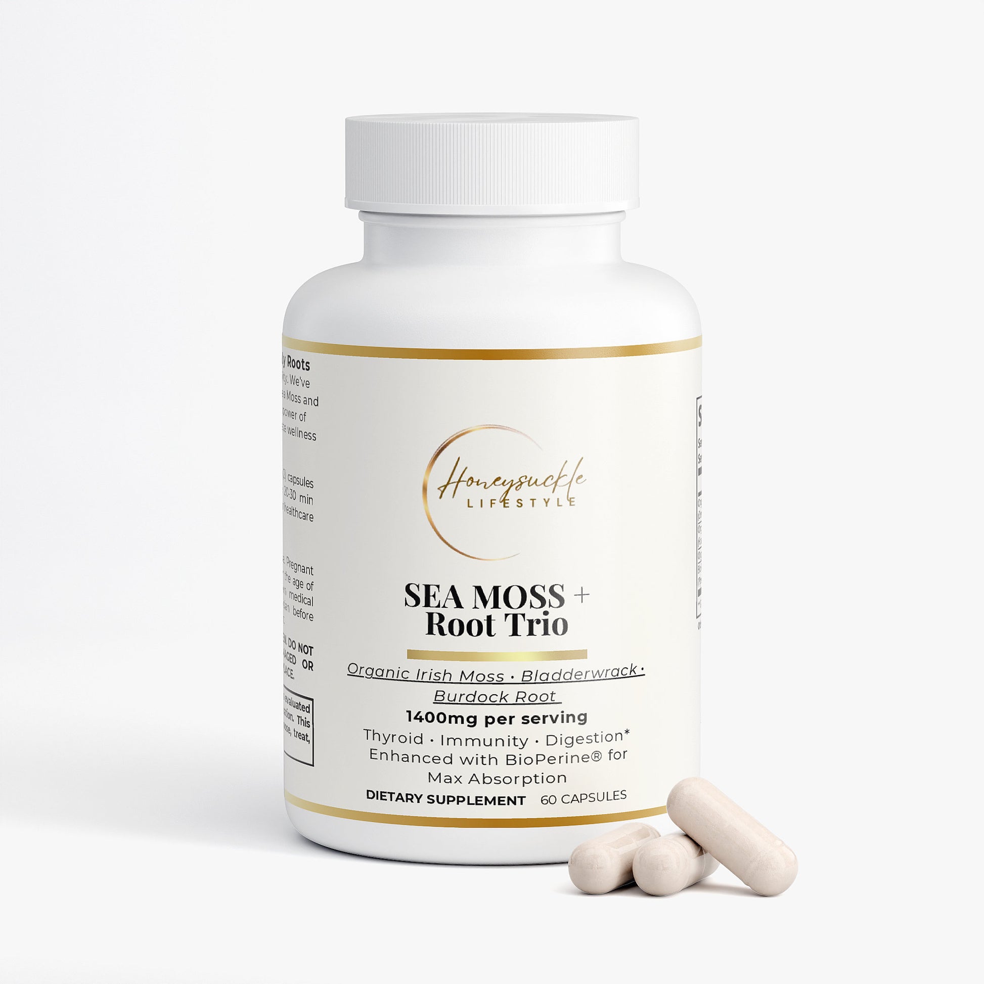 Supplement bottle labeled 'Sea Moss + Root Trio' with two capsules on a white background