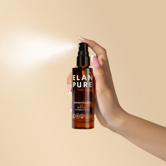 Hand holding a bottle of ELAN PURE tanning lotion against a beige background