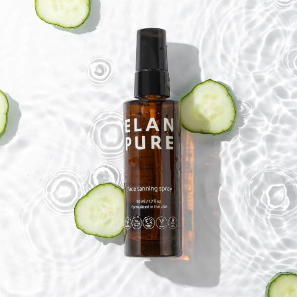 Brown spray bottle labeled 'ELAN PURE' with sliced cucumbers on a light background