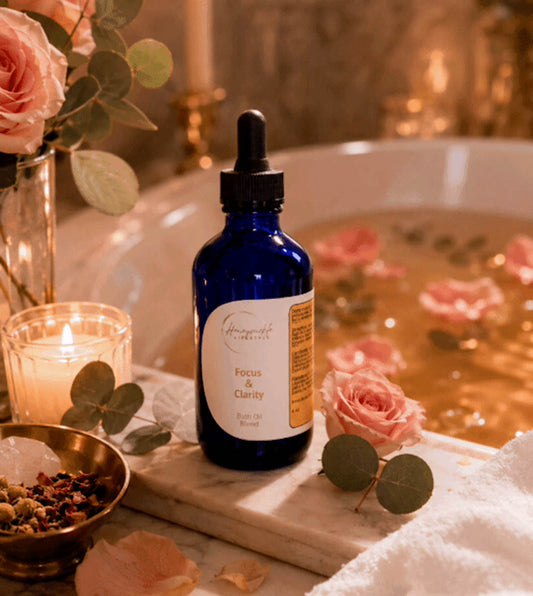 Blue bottle with dropper on a tray with flowers and candles in the background